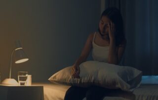 woman experiencing insomnia in bed, can’t fall asleep