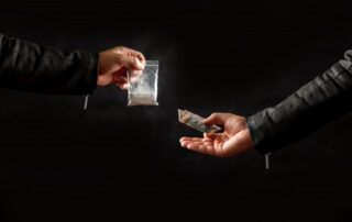 a person buying drugs from a dealer