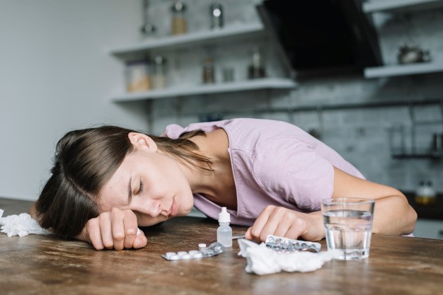 a young woman experiencing headache as a result of drug addiction
