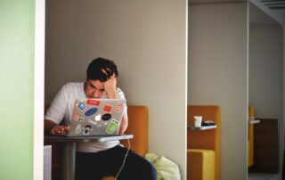 Man looking stressed working on laptop