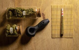 Cannabis stored in jars with a rolled joint