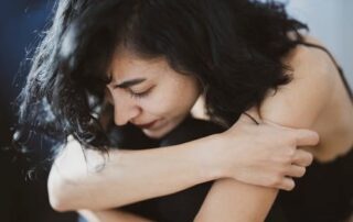 A woman suffering from chronic pain related to fibromyalgia.