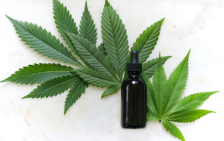 marijuana leaves and bottle on a table