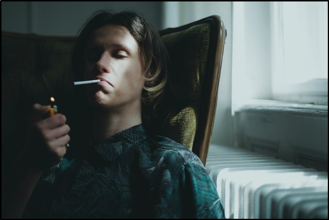man smoking at a home and relaxing