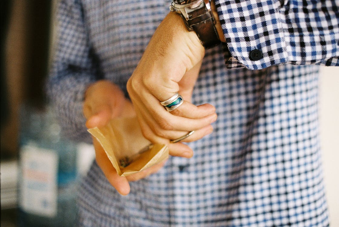 A person making a marijuana joint