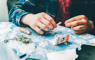 Man-rolling-a-paper-of-weed