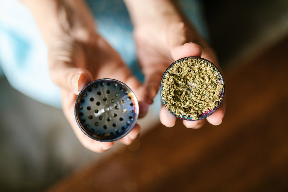 Dried marijuana leaves in a tin