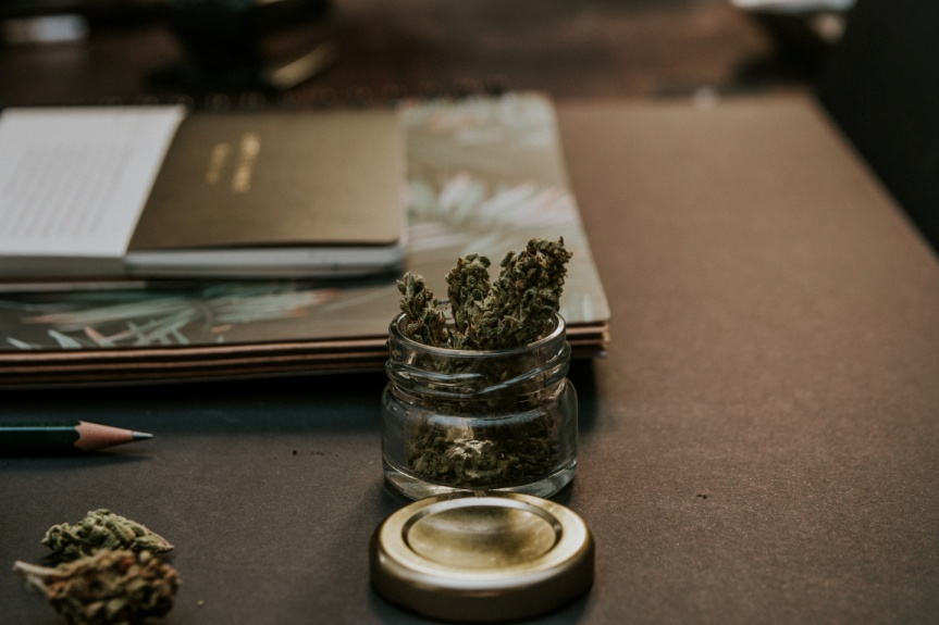 Cannabis in a glass container placed on a table
