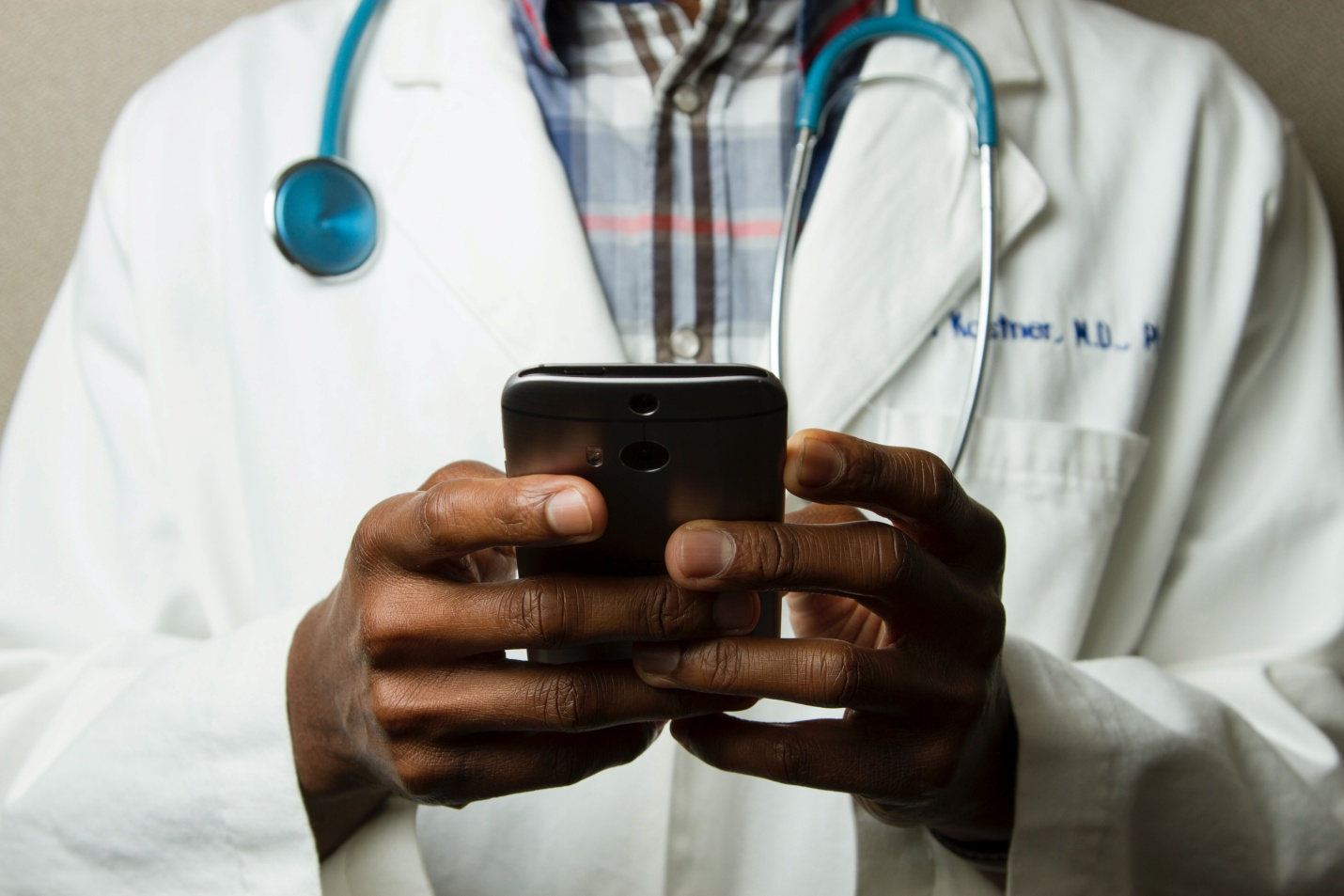 A doctor holding a cell phone